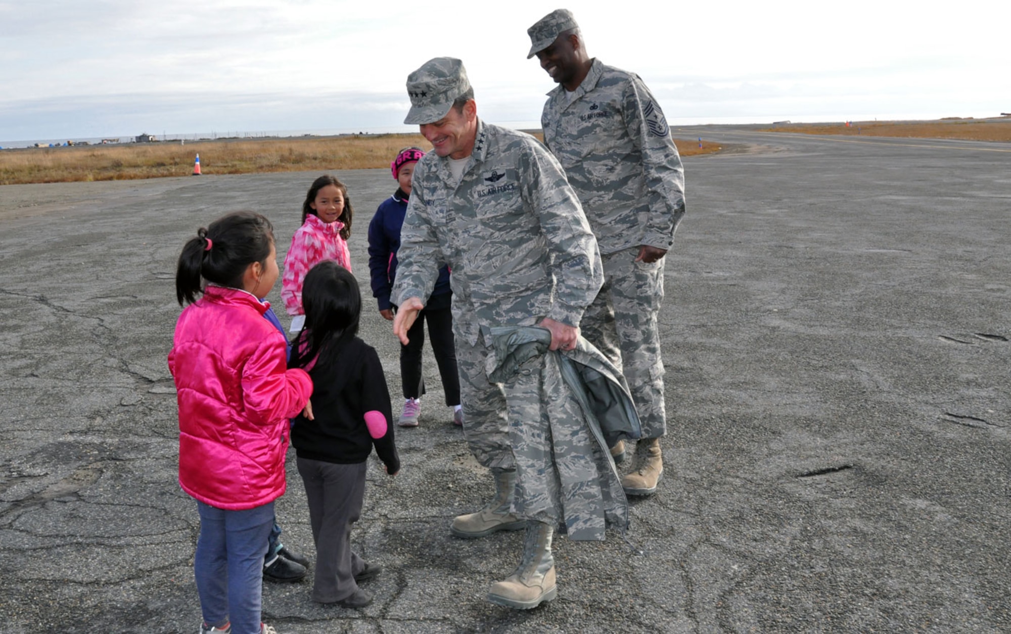 U.S. Air Force Lt. Gen. Russ Handy, Alaskan Command commander, and Chief Master Sgt. Jerry Moore, 11th Air Force command chief, greet children of the Native Village of Shishmaref during a trip to western Alaska October 1, 2014. Alaskan Command leadership was able to gain insight on the life and challenges of Alaska Native Tribes and tour and meet with the residents of the native villages of Wales and Shishmaref as well as the Nome Eskimo Community. (U.S. Air Force photo/Capt. Anastasia Wasem)