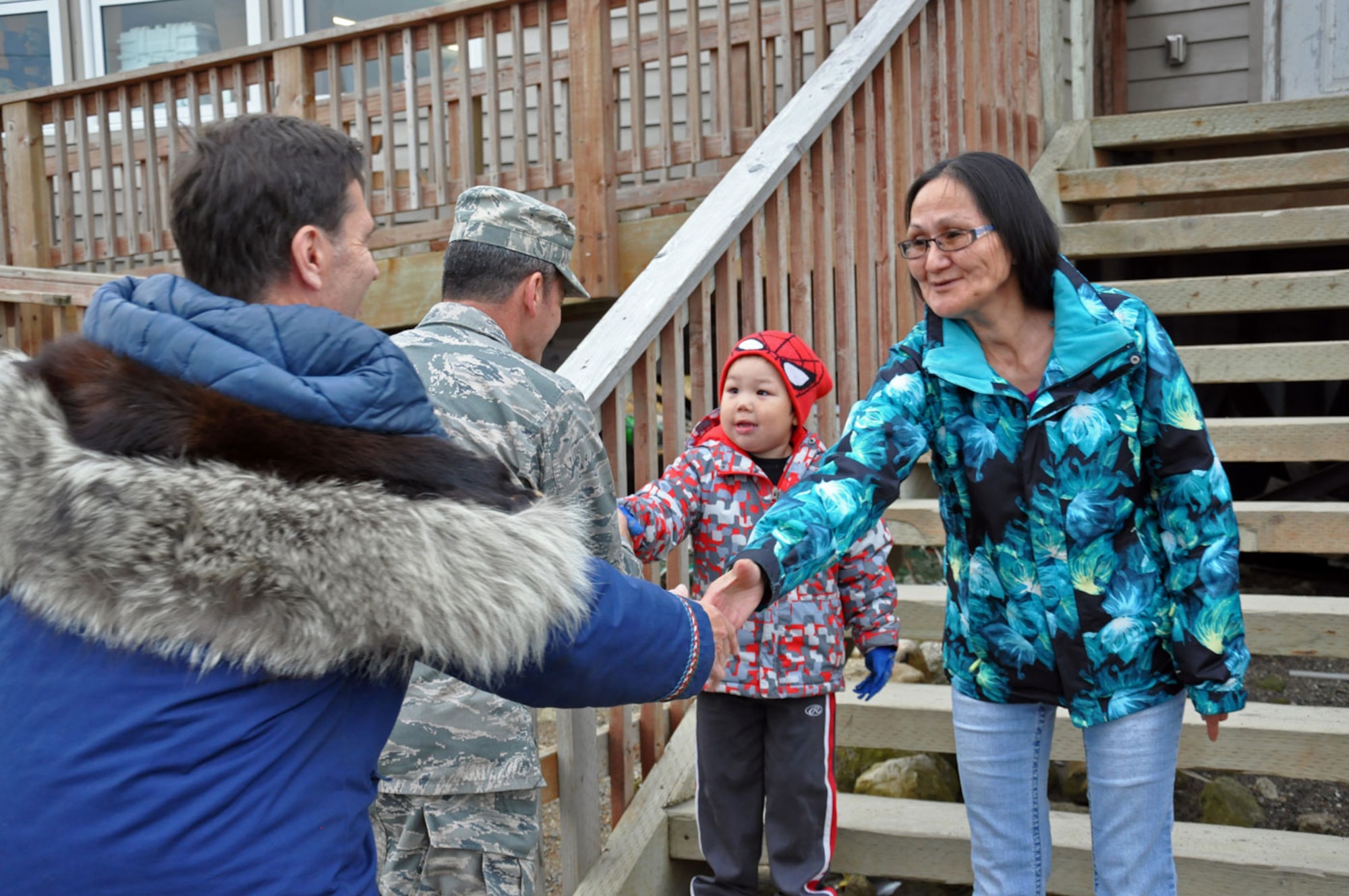 U.S. Air Force Lt. Gen. Russ Handy, Alaskan Command commander, Dr. Jerome Montague, Alaskan Command Native Affairs and Natural Resources advisor, meet with Anna Oxereok, Native Village of Wales president and three-year-old Frank Komonaseak during a trip to western Alaska October 1, 2014. Alaskan Command leadership was able to gain insight on the life and challenges of Alaska Native Tribes and tour and meet with the residents of the native villages of Wales and Shishmaref as well as the Nome Eskimo Community. (U.S. Air Force photo/Capt. Anastasia Wasem)