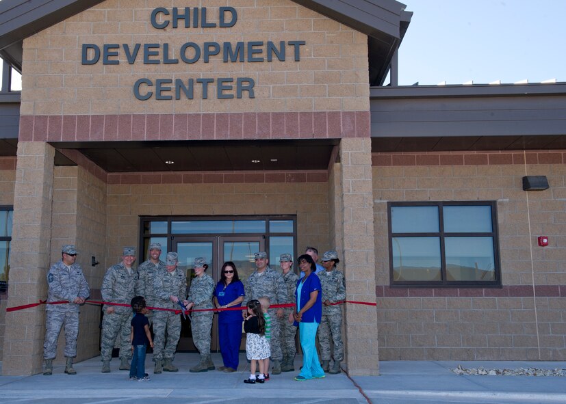 Key members of Team Holloman cut the ribbon at the new Child Development Center at Holloman Air Force Base, N.M. Oct. 1. “The new CDC is a long term solution to solve many issues that parents have had to overcome the last few years,” said Col. Robert Kiebler, 49th Wing commander. Once fully operational the new CDC can accommodate 200 children. Lt. Col. Matthew Sandelier, 49th  Force Support Squadron commander, stated that the new CDC is said to enhance the ability to provide care for the children and increase the number of children they can provide development to. (U.S. Air Force photo by Staff Sgt. E’Lysia Wray/Released)