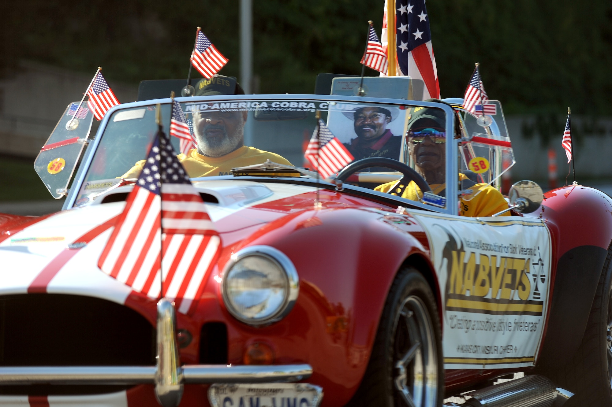 A Vietnam veteran of the National Association of Black Veterans drives a classic Mustang in the American Royals Parade Sept. 27, 2014, in Kansas City, Mo. Veterans from various conflicts, active duty Service members as well as Boy Scouts participated in marching in this year's parade.  (U.S. Air Force photo by Airman 1st Class Jovan Banks/Released)
