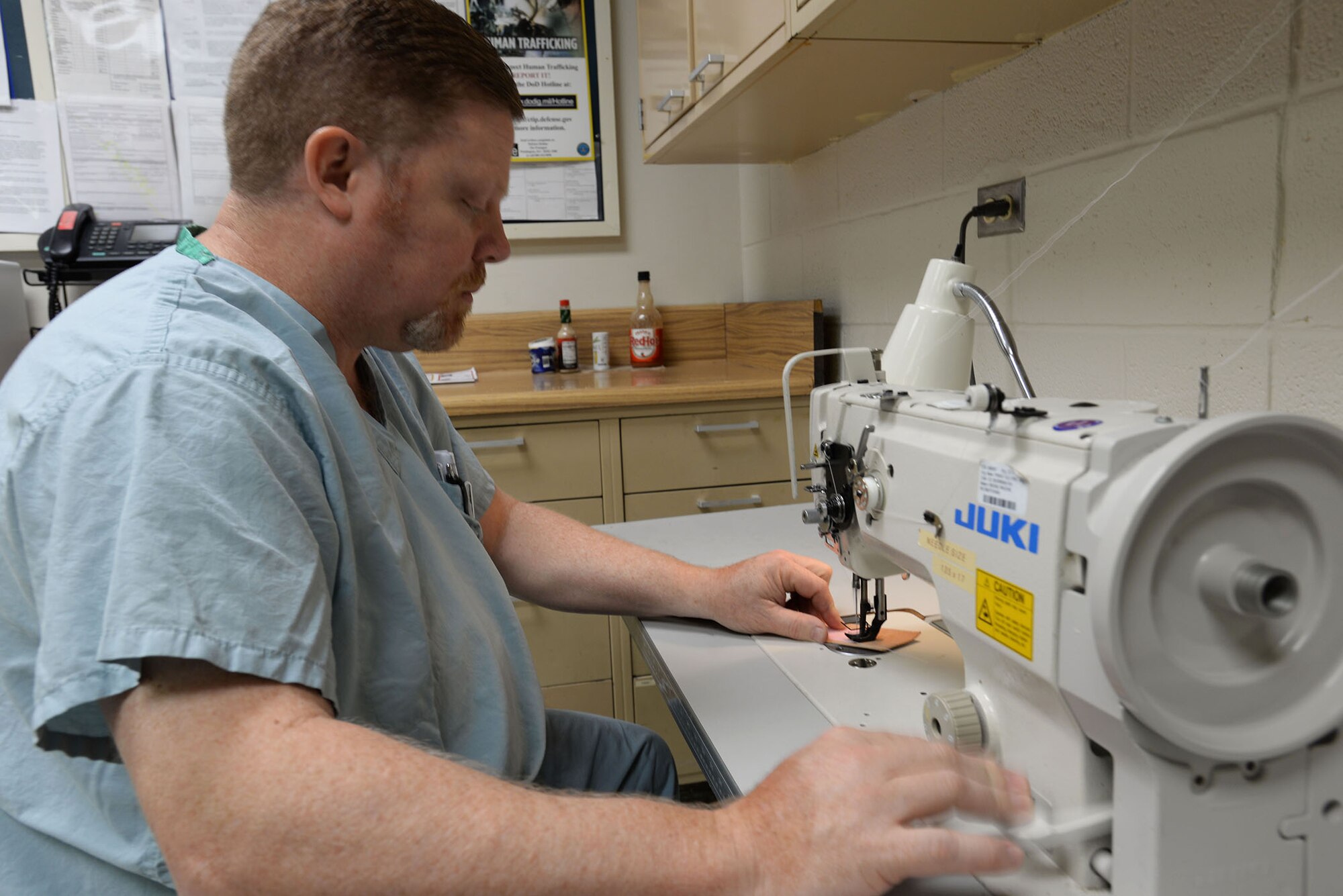 Lawrence New, 59th Medical Operations Group orthotist, sews leather backing onto a Velcro strap for a custom brace Sept. 4, 2014 in the Orthotic Lab at the Wilford Hall Ambulatory Surgical Center on Joint Base San Antonio-Lackland, Texas. The Orthotic Lab is able to create custom supports and braces for military members as well as retirees and dependents. (U.S. Air Force photo/Staff Sgt. Christopher Carwile/Released)