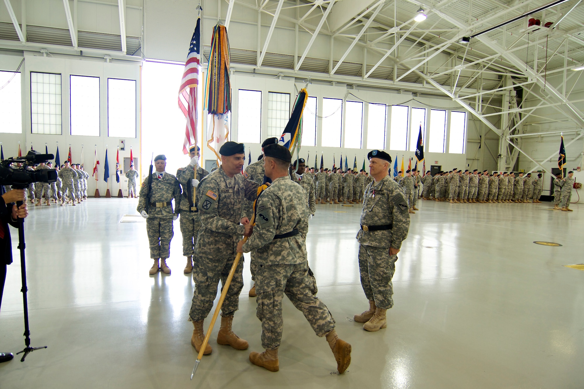 Maj. Gen. James "Boe" Young Jr., commanding general of the 75th Training Command, passes the colors to Brig. Gen. Alberto C. Rosende, the incoming commander of the Atlantic Division, 75th Training Command, at a Change of Command ceremony for the Atlantic Division, 75th Training Command, at Joint Base McGuire-Dix-Lakehurst, N.J., Oct. 4, 2014. (Photo by Army Staff Sgt. Daryl Madrid, Released)