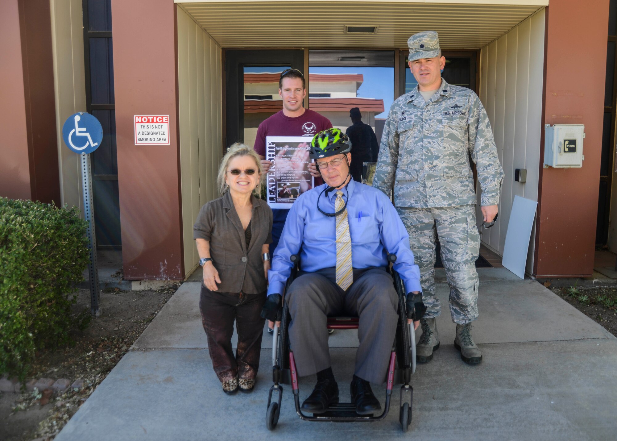 James Judkins (seated), 412th Civil Engineer Group director, takes on the wheelchair challenge Oct. 6. The challenge is to give leaders a better perspective of people with disabilities. A helmet was provided as Judkins is not accustomed to using a wheelchair. To the left is Darcy Painter, 412th Communications Squadron, Disability Employment Awareness Month Committee member; to the right is Lt. Col. Christopher Budde, 412th CS commander. Behind is Senior Airman Gregory Smith, 412th Security Forces Squadron, DEAM Committee member. (U.S. Air Force photo by Rebecca Amber)