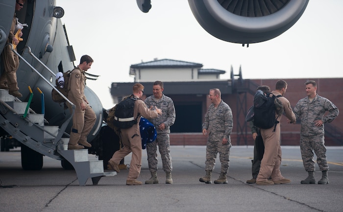 Joint Base Charleston leadership welcomes home members of the 15th Airlift Squadron during their redeployment Oct. 2, 2014, at Joint Base Charleston, S.C. The 15th Airlift Squadron is returning from a two-month deployment to Southwest Asia.  Under the new Lead Wing Construct, the 15th Airlift Squadron was responsible for all three deployed C-17 bases in the Persian Gulf, executing up to 98 combat missions a week. With a 47 percent increase in manning requirements, the 15th AS received help from every one of Joint Base Charleston's active-duty sister squadrons, every 315th Airlift Wing Reserve Squadron and the Memphis Air National Guard.  They formed a formidable Total Force Integration team with phenomenal executional results that delivered more than 73 million pounds of cargo flying more than 4,400 combat hours. (U.S. Air Force photo/Senior Airman George Goslin)