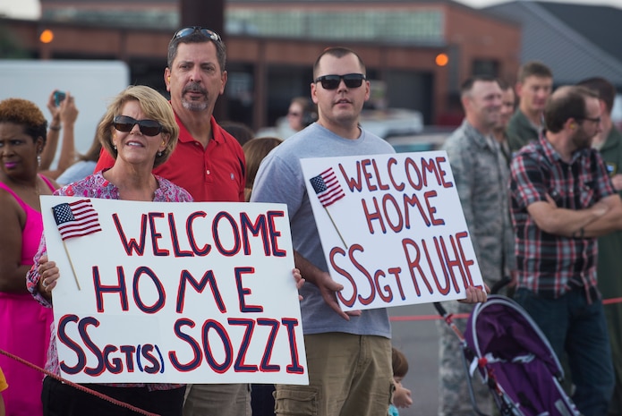 Family members and loved ones await the return of the members from the 15th Airlift Squadron during their redeployment, Oct. 2, 2014, at Joint Base Charleston, S.C. The 15th Airlift Squadron is returning from a two-month deployment to Southwest Asia.  Under the new Lead Wing Construct, the 15th Airlift Squadron was responsible for all three deployed C-17 bases in the Persian Gulf, executing up to 98 combat missions a week. With a 47 percent increase in manning requirements, the 15th AS received help from every one of Joint Base Charleston's active-duty sister squadrons, every 315th Airlift Wing Reserve Squadron and the Memphis Air National Guard.  They formed a formidable Total Force Integration team with phenomenal executional results that delivered more than 73 million pounds of cargo flying more than 4,400 combat hours. (U.S. Air Force photo/Senior Airman George Goslin)