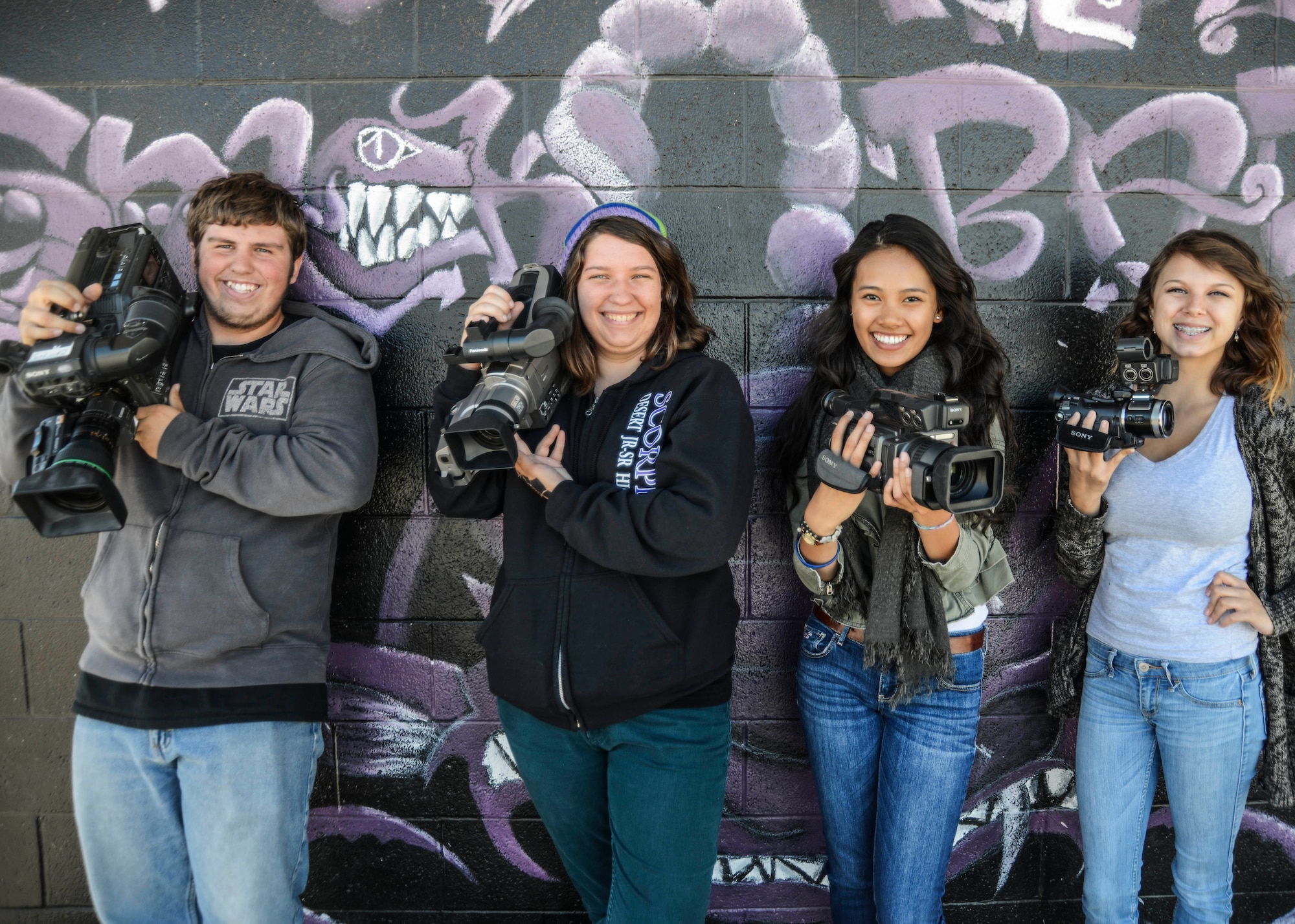 Aric Springer, Emily Vernon, Jennifer Phan and Tabitha Stankewitz are excited about putting their new equipment to use and incorporate video into their yearbook. (U.S. Air Force photo by Rebecca Amber)