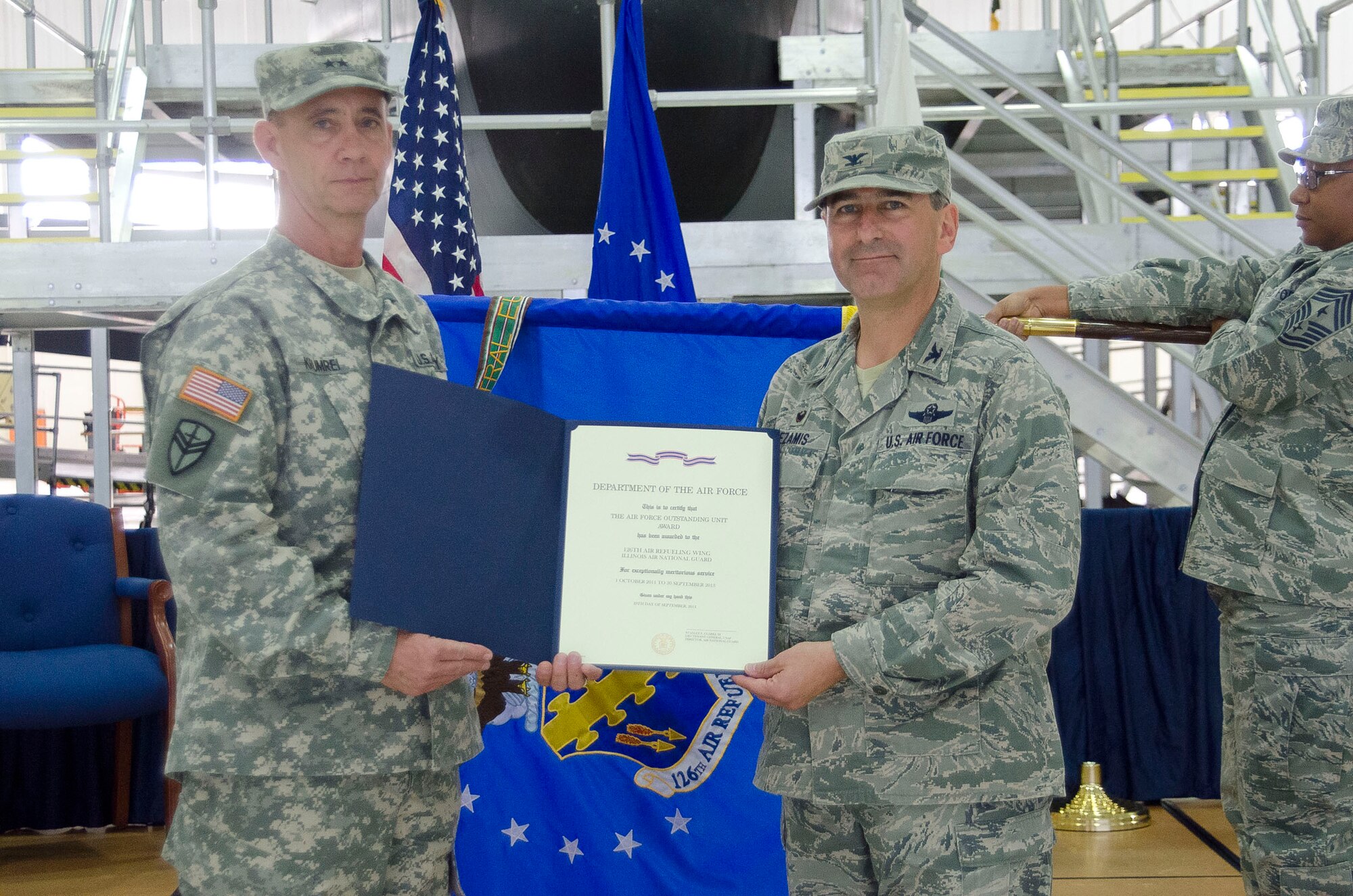 Army Maj. Gen. Daniel M. Krumrei (left), the 38th Adjutant General of the State of Illinois, presents the Air Force Oustanding Unit Award to Col. Peter Nezamis, Commander of the 126th Air Refueling Wing, at Scott Air Force Base, Saturday, Oct. 4, 2014. The Illinois Air National Guard unit received the award for distinguishing itself for exceptionally meritorious service from Oct. 1, 2011 to Sept. 30, 2013. (Air National Guard photo by Master Sgt. Ken Stephens)