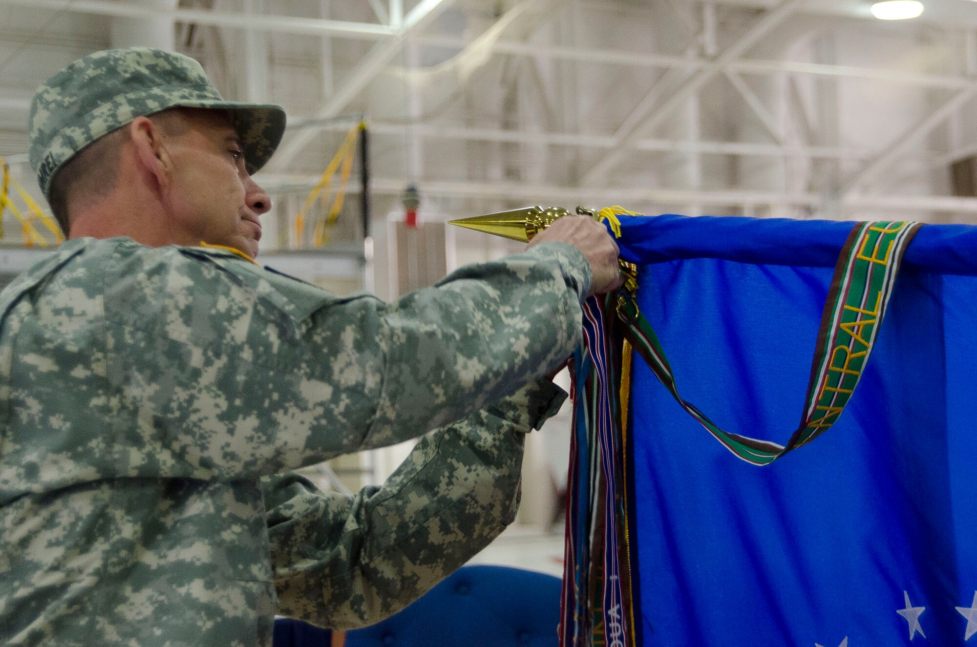 Army Maj. Gen. Daniel M. Krumrei, the 38th Adjutant General of the State of Illinois, attaches the Air Force Oustanding Unit Award banner to the 126th Air Refueling Wing flag at Scott Air Force Base, Saturday, Oct. 4, 2014. The Illinois Air National Guard unit received the award for distinguishing itself for exceptionally meritorious service from Oct. 1, 2011 to Sept. 30, 2013. (Air National Guard photo by Master Sgt. Ken Stephens)
