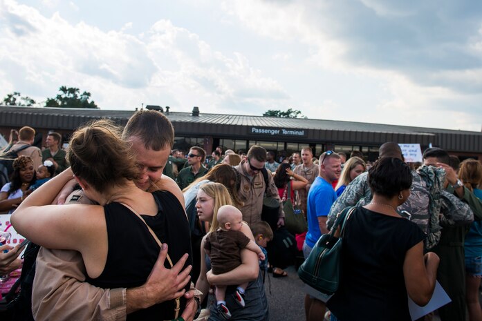 Members of the 15th Airlift Squadron return to their loved ones after arriving home from a deployment Oct. 2, 2014, at Joint Base Charleston, S.C. The 15th Airlift returned home after a two-month deployment to Southwest Asia.  Under the new Lead Wing Construct, the 15th Airlift Squadron was responsible for all three deployed C-17 bases in the Persian Gulf, executing up to 98 combat missions a week. With a 47 percent increase in manning requirements, the 15th AS received help from every one of Joint Base Charleston's active-duty sister squadrons, every 315th Airlift Wing Reserve Squadron and the Memphis Air National Guard.  They formed a formidable Total Force Integration team with phenomenal executional results that delivered more than 73 million pounds of cargo flying more than 4,400 combat hours. (U.S. Air Force photo/Senior Airman George Goslin)