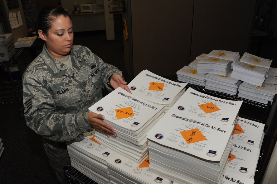 Staff Sgt. Vanessa Glenn, Community College of the Air Force student services technician, organizes the diplomas for the October graduating class at the CCAF headquarters at Maxwell-Gunter Air Force Base, Ala., Sep. 17, 2014. There were 13,042 diplomas printed off for the graduates of the October class. (U.S. Air Force photo by Airman 1st Class Alexa Culbert)