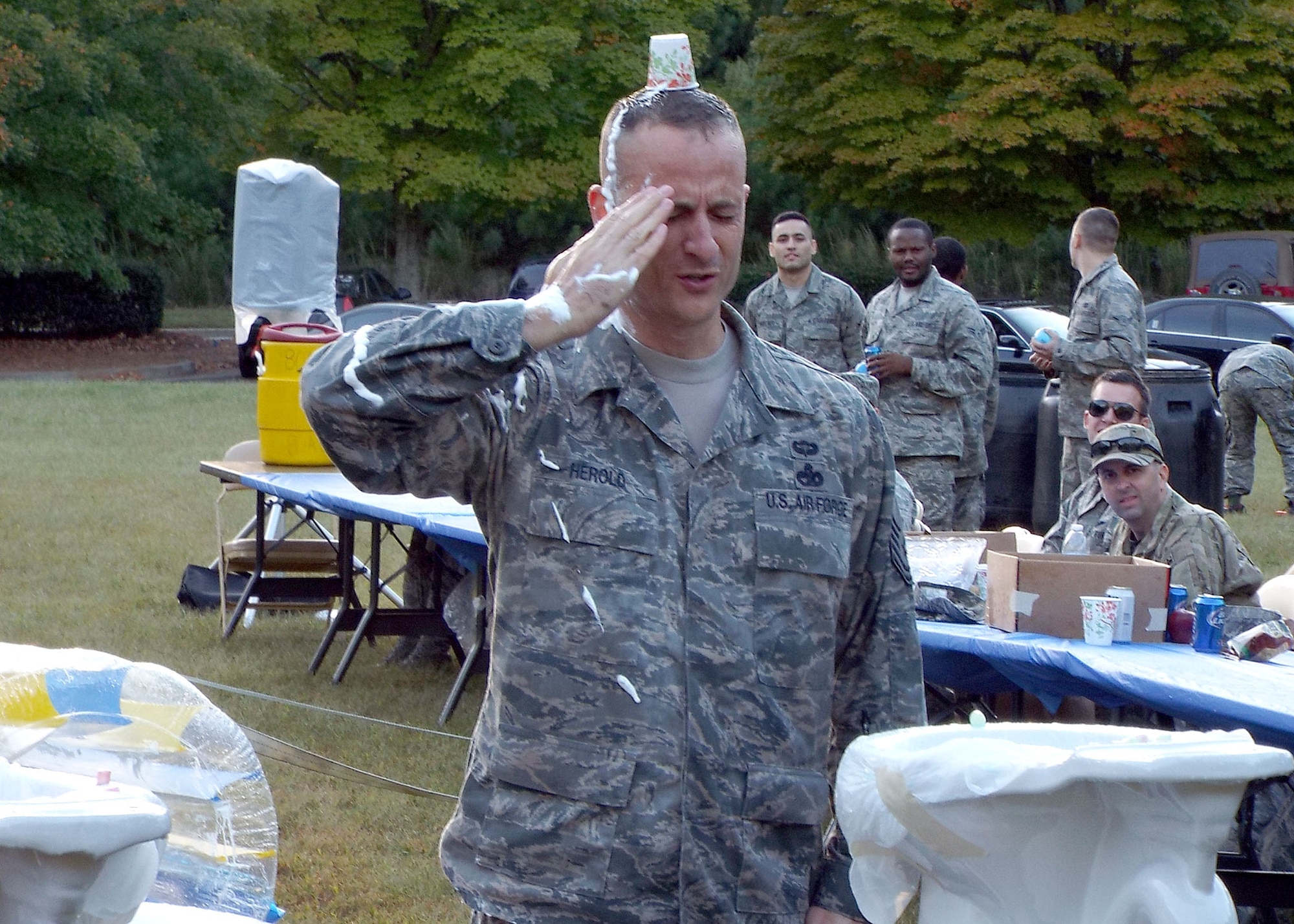 Chief Master Sgt. Jeffrey Herold, 80th Aerial Port Squadron, reports to Maj. Kelly Bronson, 80th APS commander and combat dining in president, after completing the obstacle course at the unit combat dining in Oct. 4, 2014, at Dobbins Air Reserve Base, Ga. The celebration allows Airmen of all ranks to come together and celebrate unit and individual accomplishments. (U.S. Air Force photo by Staff Sgt. Karla Lehman/Released)