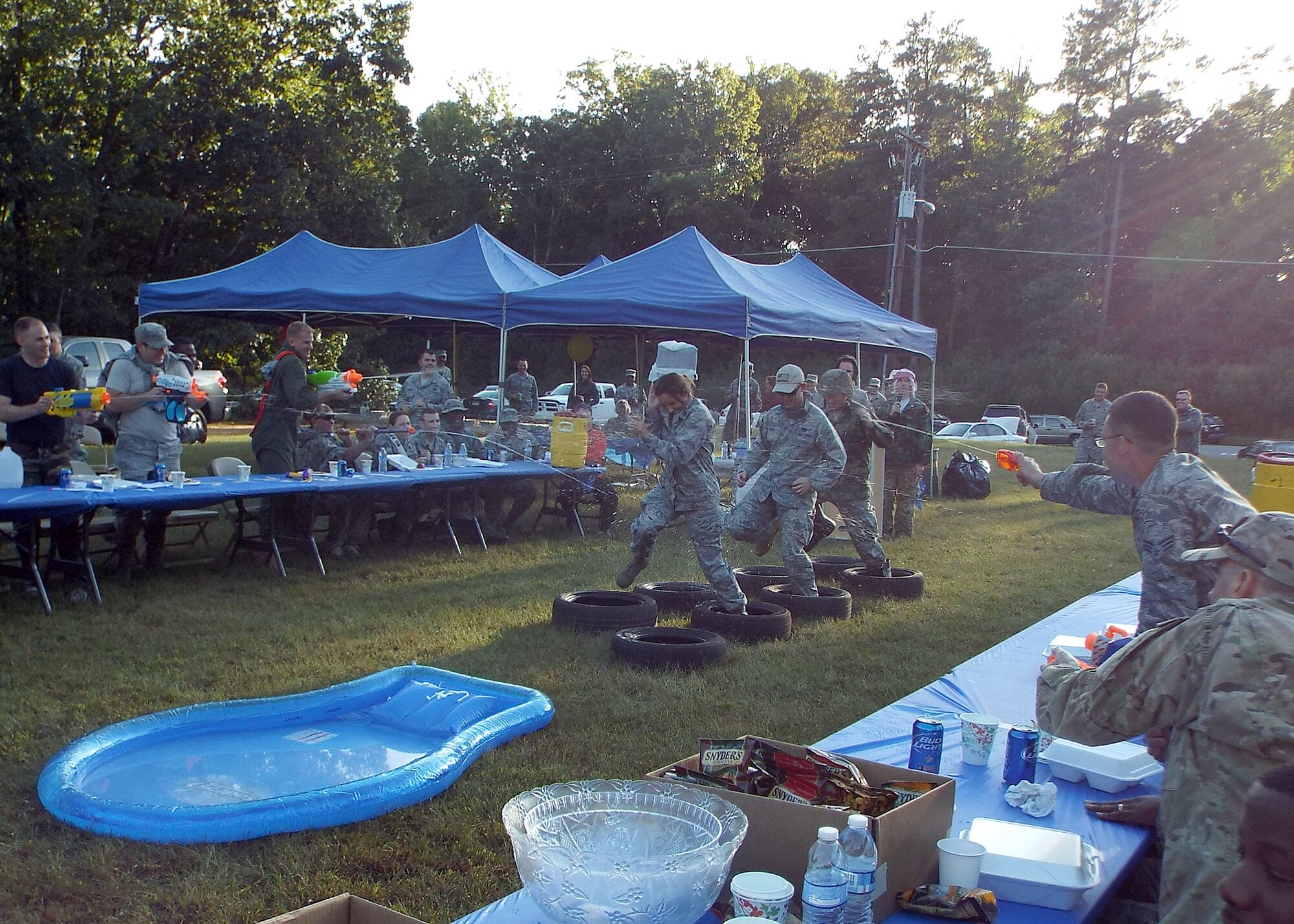 Members of the 80th Aerial Port Squadron complete the obstacle course after violating the rules at the unit’s combat dining in Oct. 4, 2014, at Dobbins Air Reserve Base, Ga. The event allows Airman of all ranks to get into a tradition of fellowship, foster relationships amongst the squadron, and celebrate the unit accomplishments. (U.S. Air Force photo by Staff Sgt. Karla Lehman/Released)