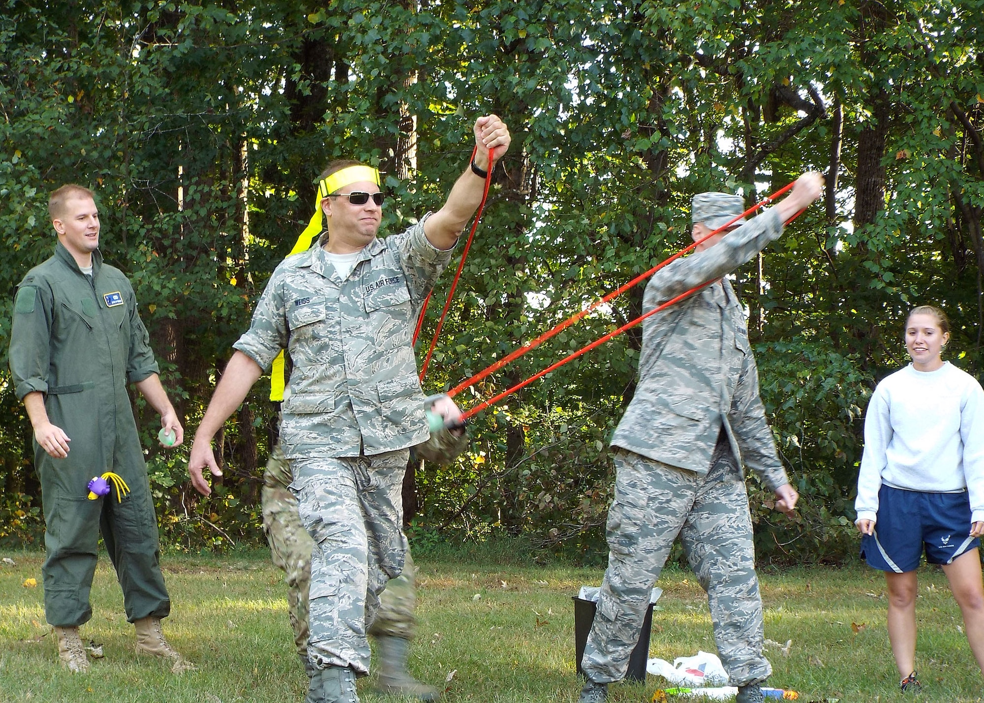 Members of the 80th Aerial Port Squadron participate in a water balloon toss at their unit combat dining in Oct. 4, 2014, at Dobbins Air Reserve Base, Ga. The celebration allows Airmen of all ranks to come together and celebrate unit and individual accomplishments. (U.S. Air Force photo by Staff Sgt. Karla Lehman/Released)