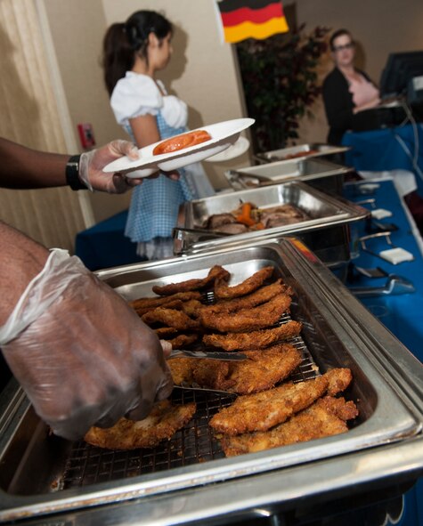 A server prepares a plate of German food for a guest at an Oktoberfest event Oct. 3, 2014, at Moody Air Force Base, Ga. The event featured traditional German food including schnitzel, sauerbraten, bratwurst, sauerkraut, spaetzle, red cabbage and German chocolate cupcakes. (U.S. Air Force photo by Senior Airman Jarrod Grammel/Released)
