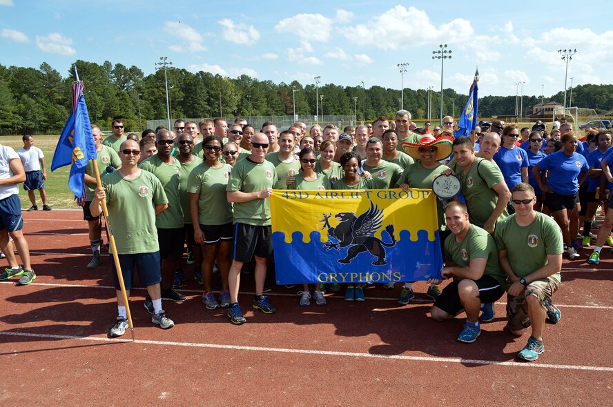 43rd Logistics Readiness Squadron Airmen pose for a group photo after winning 1st place with the 43rd Force Support Squadron in the 43rd Airlift Group’s Comprehensive Airman Fitness sports day sponsored by the Air Force Sergeants Association, Chapter 367, on Oct. 3 at Pope Army Airfield, N.C. Activities included track and field events, mushball, softball, walleyball, basketball, dodgeball, tug-o-war, cornhole and a 3-mile ruck march. Squadron teams competed for trophies and the Group’s spirit flag. (U.S. Air Force photo/Marvin Krause)