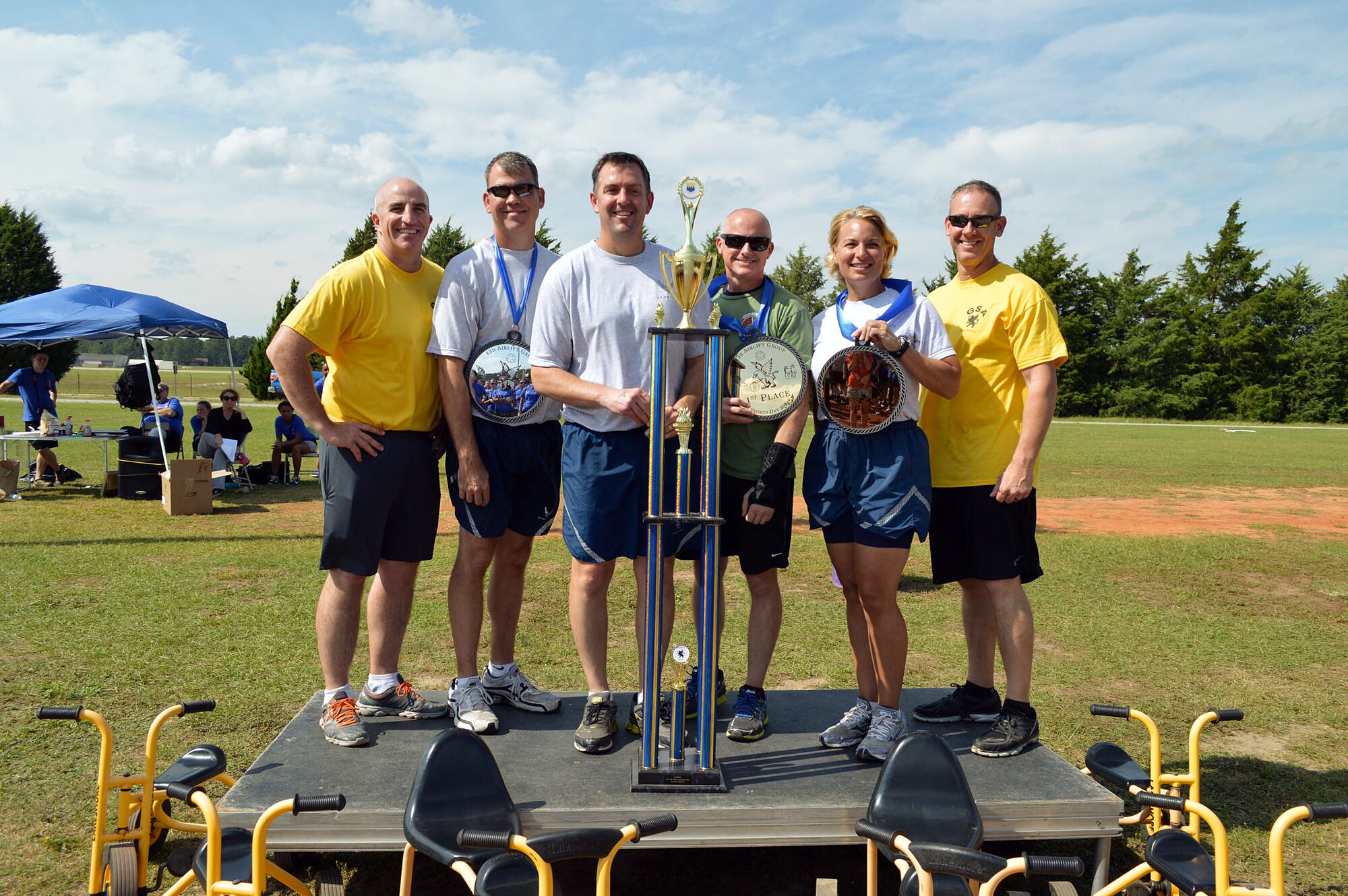 Col. Kenneth Moss, 43rd Airlift Group commander, and Chief Master Sgt. James Cope, 43rd Airlift Group superintendent, present Comprehensive Airman Fitness sports day awards to Lt. Col. Patrick O’Sullivan, 2nd Airlift Squadron commander, Lt. Col. Brian Ballew, 43rd Force Support Squadron commander, Maj. Peyton Smith, 43rd Logistics Readiness Squadron commander, and Col. Elizabeth Shaw, 43rd Aeromedical Evacuation Squadron commander, during the Comprehensive Airman Fitness sports day sponsored by the Air Force Sergeants Association, Chapter 367, on Oct. 3 at Pope Army Airfield, N.C. Activities included track and field events, mushball, softball, walleyball, basketball, dodgeball, tug-o-war, cornhole and a 3-mile ruck march. Squadron teams competed for trophies and the Group’s spirit flag. The 43rd Logistics Readiness Squadron and 43rd Force Support Squadron combined efforts to win 1st place overall and capture the Group’s spirit flag. (U.S. Air Force photo/Marvin Krause)