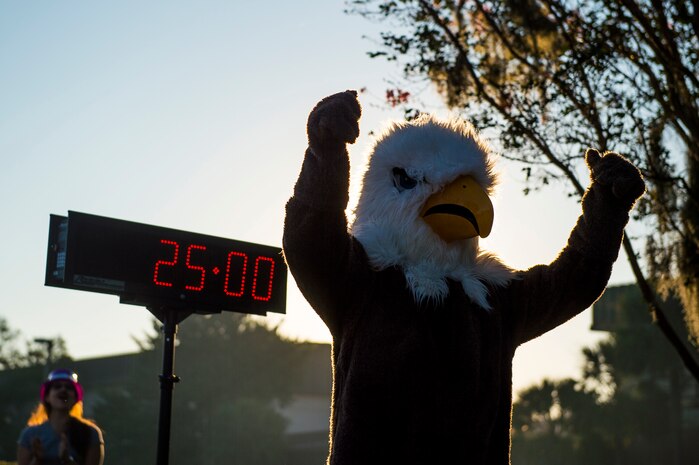 Ernie the Eagle, mascot for Combat Camera, cheers on runners at the finish line during the commander’s challenge 5k run, Oct. 3, 2014, at Joint Base Charleston, S.C. The runners were welcome to dress in costume for the Halloween spirit. The fastest male runner was Capt. Christopher Love, 628th Air Base Wing public affairs officer, with a time of 18:22. The fastest female runner was Capt. Marie Harnley, 628th Civil Engineer Squadron operations engineering chief, with a time of 20:57. (U.S. Air Force photo/Senior Airman George Goslin)