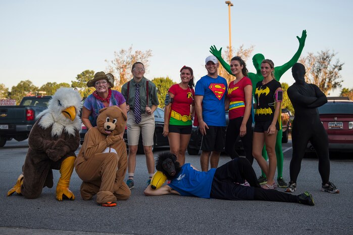 Costumed Airmen pose for a group photo after the commander’s challenge 5k run, Oct. 3, 2014, at Joint Base Charleston, S.C. The runners were welcome to dress in costume to get into the Halloween spirit. The fastest male runner was Capt. Christopher Love, 628th Air Base Wing public affairs officer, with a time of 18:22. The fastest female runner was Capt. Marie Harnley, 628th Civil Engineer Squadron operations engineering chief, with a time of 20:57. (U.S. Air Force photo/Senior Airman George Goslin)