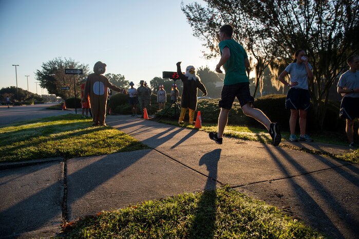 A runner crosses the finish line during the commander’s challenge 5k run Oct. 3, 2014, at Joint Base Charleston, S.C. Commander's challenge runs are held once a month at the Air Base fitness center. The fastest male runner was Capt. Christopher Love, 628th Air Base Wing public affairs officer, with a time of 18:22. The fastest female runner was Capt. Marie Harnley, 628th Civil Engineer Squadron operations engineering chief, with a time of 20:57. (U.S. Air Force photo/Senior Airman George Goslin)