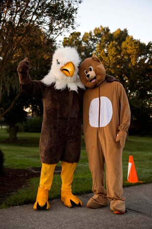 Costumed Airmen pose for a photo at the finish line during the commander’s challenge 5k run Oct. 3, 2014, at Joint Base Charleston, S.C. The runners were welcome to dress in costume to get into the Halloween spirit. The fastest male runner was Capt. Christopher Love, 628th Air Base Wing public affairs officer, with a time of 18:22. The fastest female runner was Capt. Marie Harnley, 628th Civil Engineer Squadron operations engineering chief, with a time of 20:57. (U.S. Air Force photo/Senior Airman George Goslin)