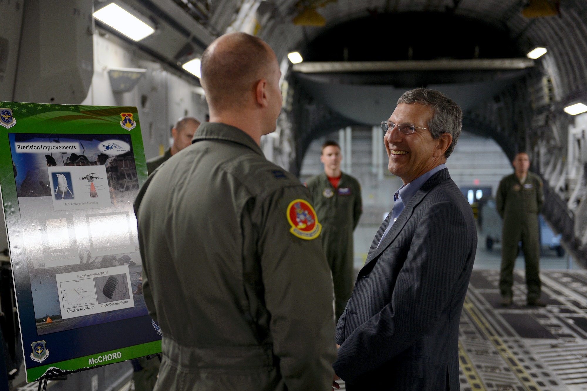 Capt. Christopher Martin (left), 10th Airlift Squadron pilot, informs the Honorable Alan Estevez, Principal Deputy Under Secretary of Defense Acquisition, Technology and Logistics, about the different types of missions the C-17 Globemaster III supports, Oct. 3, 2014, during his visit at Joint Base Lewis-McChord, Wash. Estevez was briefed on missions such as McChord Field’s role in Operation Deep Freeze, an ongoing operation in Antarctica, and along with his tour on the C-17, he took a driving tour around the 62nd Airlift Wing. (U.S. Air Force photo/Airman 1st Class Keoni Chavarria)