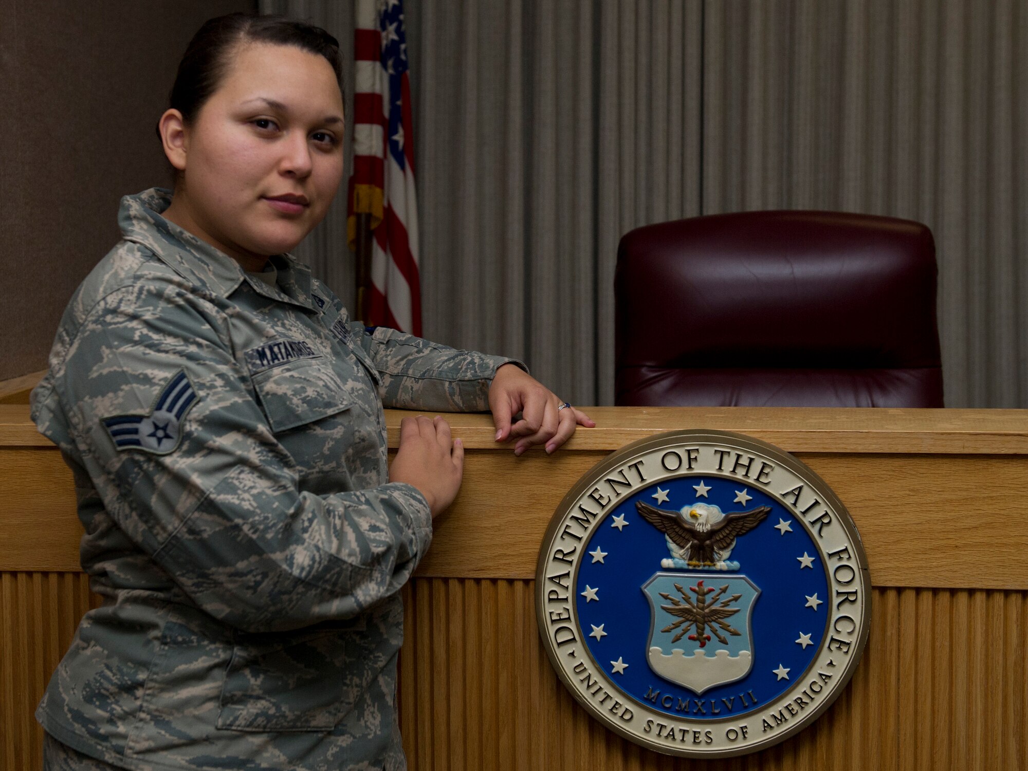 Senior Airman Andrea Matamoros, 49th Wing Judge Advocate paralegal, poses in the Holloman Air Force Base N.M., courtroom Oct. 3.  As a paralegal, Matamoros handles programs from power of attorneys to demotions and court martial, works with witnesses and victims, and watches for any issues on base that the legal office may pursue for prosecution.  “There’s a lot about our job as a paralegal that people have no idea about,” said Matamoros. “It’s definitely different than I thought, even with a heavy workload, I remember that I do make a difference.”