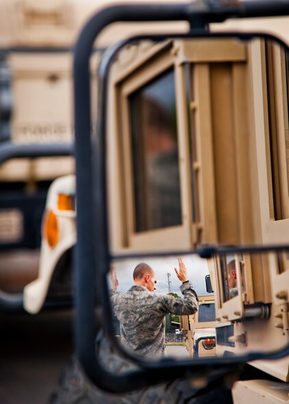 An Airman guides in the next HMMWV into position in the convoy prior to a vehicle operations combat operational readiness training exercise Oct. 3 at Eglin Air Force Base, Fla.  The training is an every-two-year requirement for all vehicle operations Airmen.  More than 20 completed the convoy operations missions that included inspections, attack scenarios and a medical evacuation.  (U.S. Air Force photo/Samuel King Jr.)