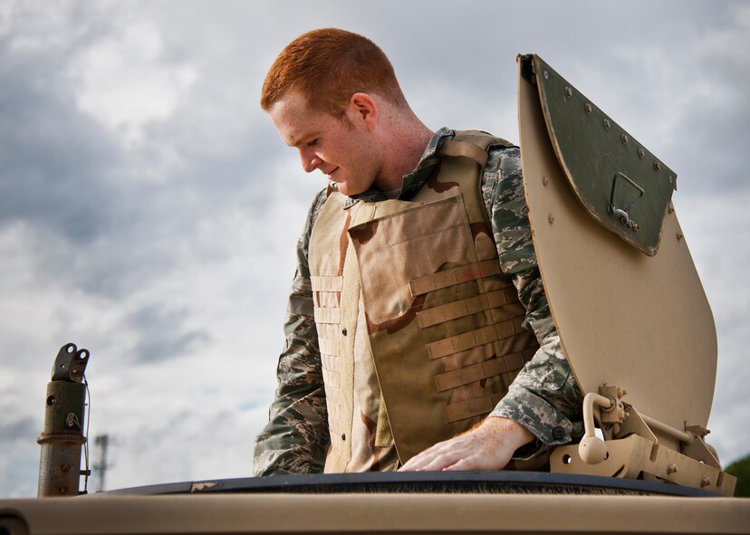 Airman Patrick Garrett-Gray, 96th Logistics Readiness Squadron vehicle operations, assumes the gunner spot in his HMMWV prior to a combat operational readiness training exercise Oct. 3 at Eglin Air Force Base, Fla.  The training is an every-two-year requirement for all vehicle operations Airmen.  More than 20 completed the convoy operations missions that included inspections, attack scenarios and a medical evacuation.  (U.S. Air Force photo/Samuel King Jr.)