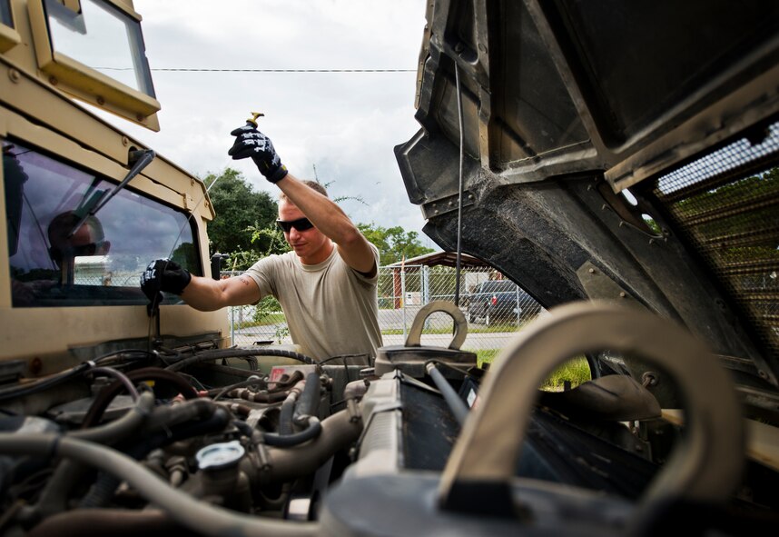 Senior Airman Jarrod Alston, 96th Logistics Readiness Squadron vehicle operations, checks the oil on his HMMWV prior to a combat operational readiness training exercise Oct. 3 at Eglin Air Force Base, Fla.  The training is an every-two-year requirement for all vehicle operations Airmen.  More than 20 completed the convoy operations missions that included inspections, attack scenarios and a medical evacuation.  (U.S. Air Force photo/Samuel King Jr.)