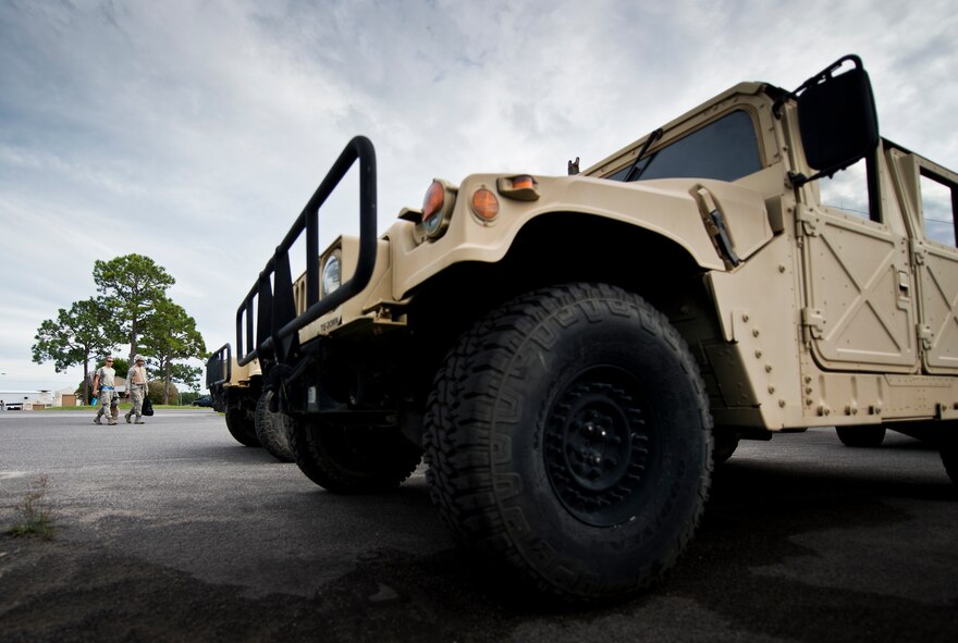 Senior Airmen Jarrod Alston and Shane Zimmerman, 96th Logistics Readiness Squadron vehicle operations, walk toward their HMMWV to prepare it for a combat operational readiness training exercise Oct. 3 at Eglin Air Force Base, Fla.  The training is an every-two-year requirement for all vehicle operations Airmen.  More than 20 completed the convoy operations missions that included inspections, attack scenarios and a medical evacuation.  (U.S. Air Force photo/Samuel King Jr.)