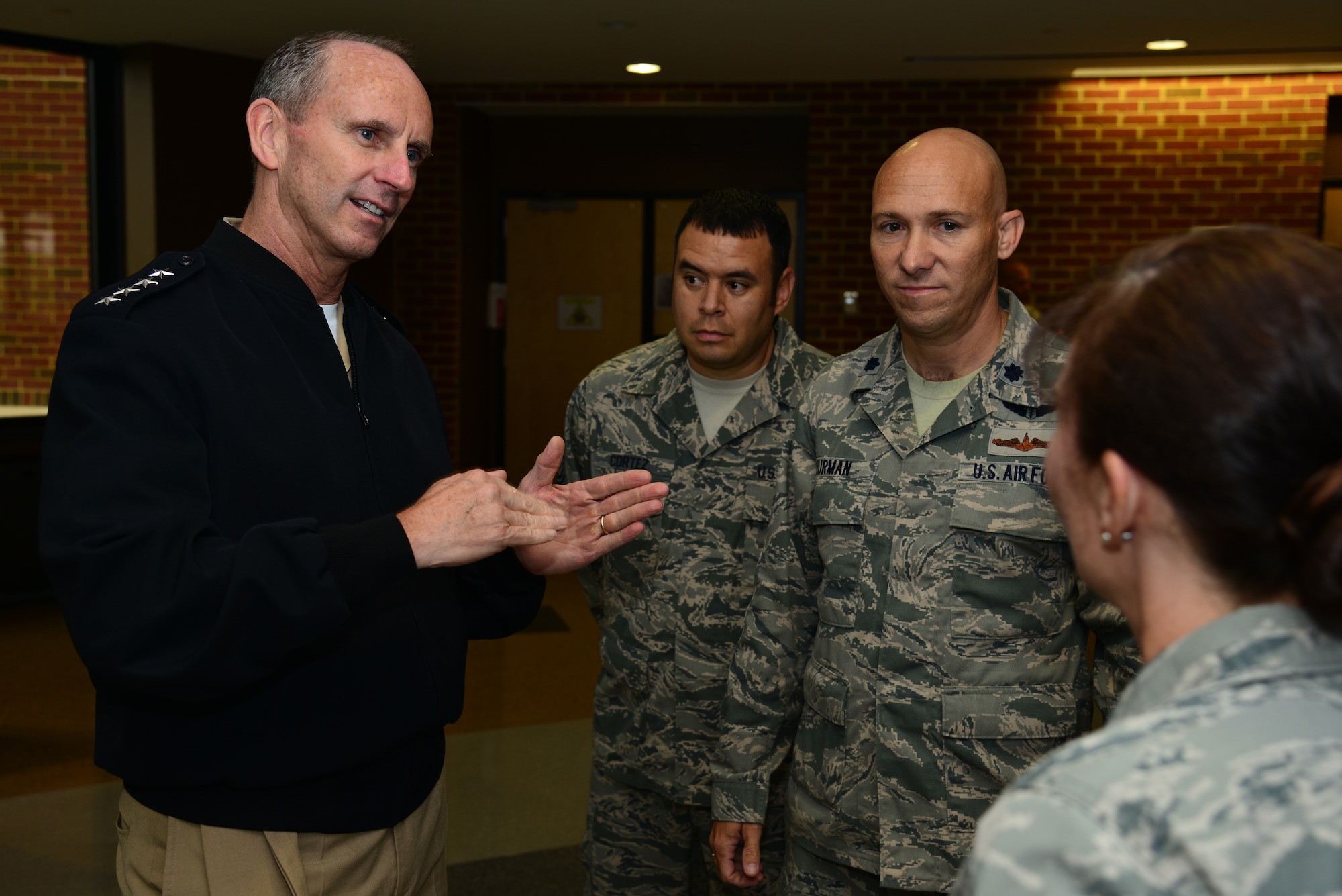 Chief of Naval Operations Adm. Jonathan Greenert speaks to 480th Intelligence, Surveillance and Reconnaissance Wing resilience team members while visiting Langley Air Force Base, Va., Sept. 24, 2014. The team is made up of medical, chaplain and mental health representatives who promote the Comprehensive Airman Fitness campaign and the importance of resilience throughout the wing. (U.S. Air Force photo by Senior Airman Aubrey White/Released)
