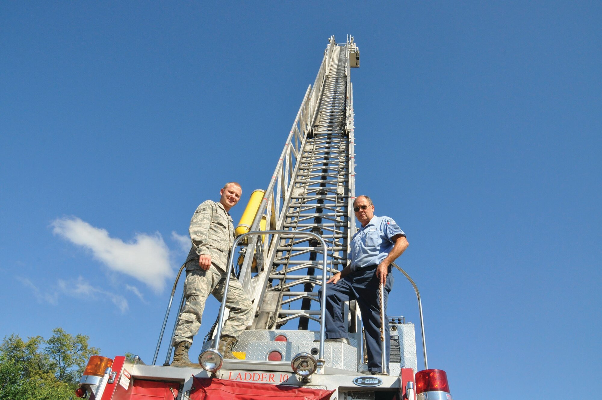 WRIGHT-PATTERSON AIR FORCE BASE, Ohio - Master Fire Technician Mr. Bob Erbaugh, a contractor with the company, Parson, and Senior Airman Jonathan Porter, 445th Logistics Readiness Squadron, look on during fire truck training focusing on working the ladder and boon on the soon to be decommissioned ladder 10 truck. (U.S. Air Force photo/Maj. Demetrius Smith)