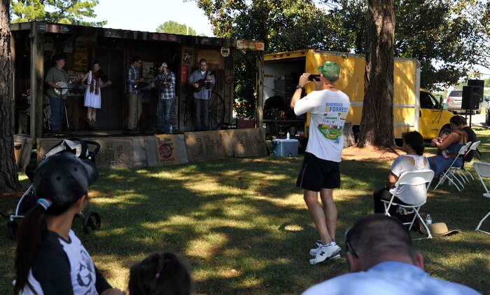 Members of Joint Base Charleston and their families listen to the Bluestone Ramblers play bluegrass music for the base's birthday bash Oct. 4, 2014, at Locklear Park on Joint Base Charleston, S.C. JB Charleston merged Charleston Air Force Base and the Naval Weapons Station into a joint base four years ago. (U.S. Air Force photo/Staff Sgt. Renae Pittman)