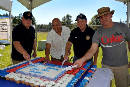 Col. Jeffrey DeVore, 628th Air Base Wing commander (third from left), along with (left to right) Master Chief Petty Officer Joseph Gardner, Naval Support Activity command master chief, Col. Jimmy Canlas, 437th Airlift Wing vice commander and Navy Capt. Timothy Sparks, 628th ABW deputy commander and NSA commanding officer, slice into the Joint Base Charleston birthday cake Oct. 4, 2014, at Locklear Park, on Joint Base Charleston, S.C. The birthday bash was open to all members of JB Charleston and hosted a variety of activities including jump castles, face painting and a live band. (U.S. Air Force photo/Staff Sgt. Renae Pittman)