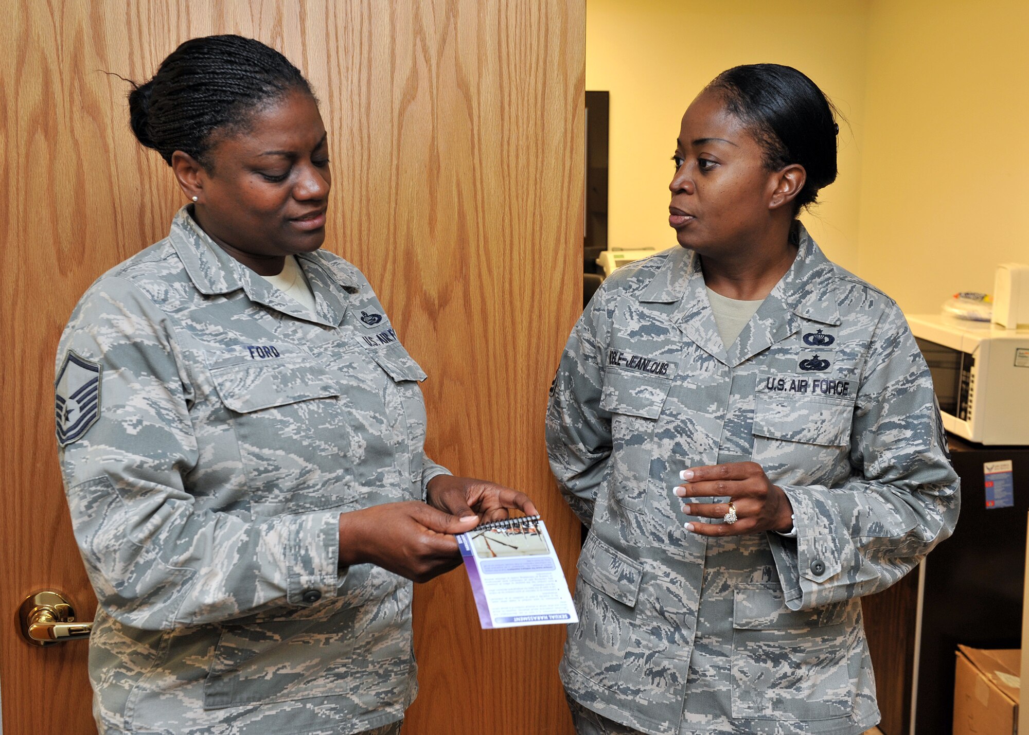 Master Sgt. Tamesia Noble-JeanLouis, 341st Missile Wing superintendent of chapel operations, right, converses with Master Sgt. Gwendolyn Ford, 341st MW equal opportunity superintendent, during a chaplain staff visit to wing staff agencies Sept. 8. (U.S. Air Force photo/John Turner)