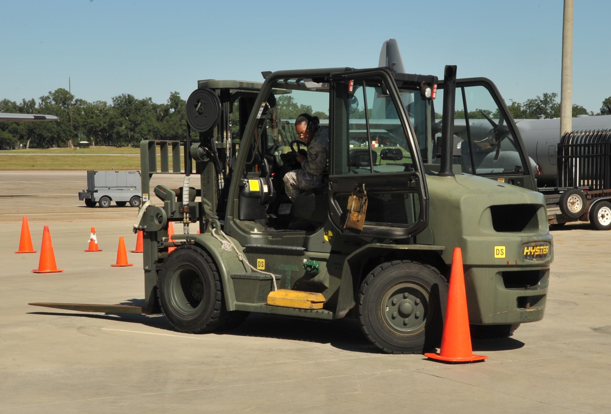 Staff Sgt. Artavie Robinson, 41st Aerial Port Squadron cargo section, maneuvers a forklift through an obstacle course during the unit’s first Port Dawg Challenge Oct. 4, 2014. Aerial porters put their skills to the test in five events that included forklift driving, pallet buildup, chains and devices tie down, fitness and professional knowledge. (U.S. Air Force photo/Maj. Marnee A.C. Losurdo)
