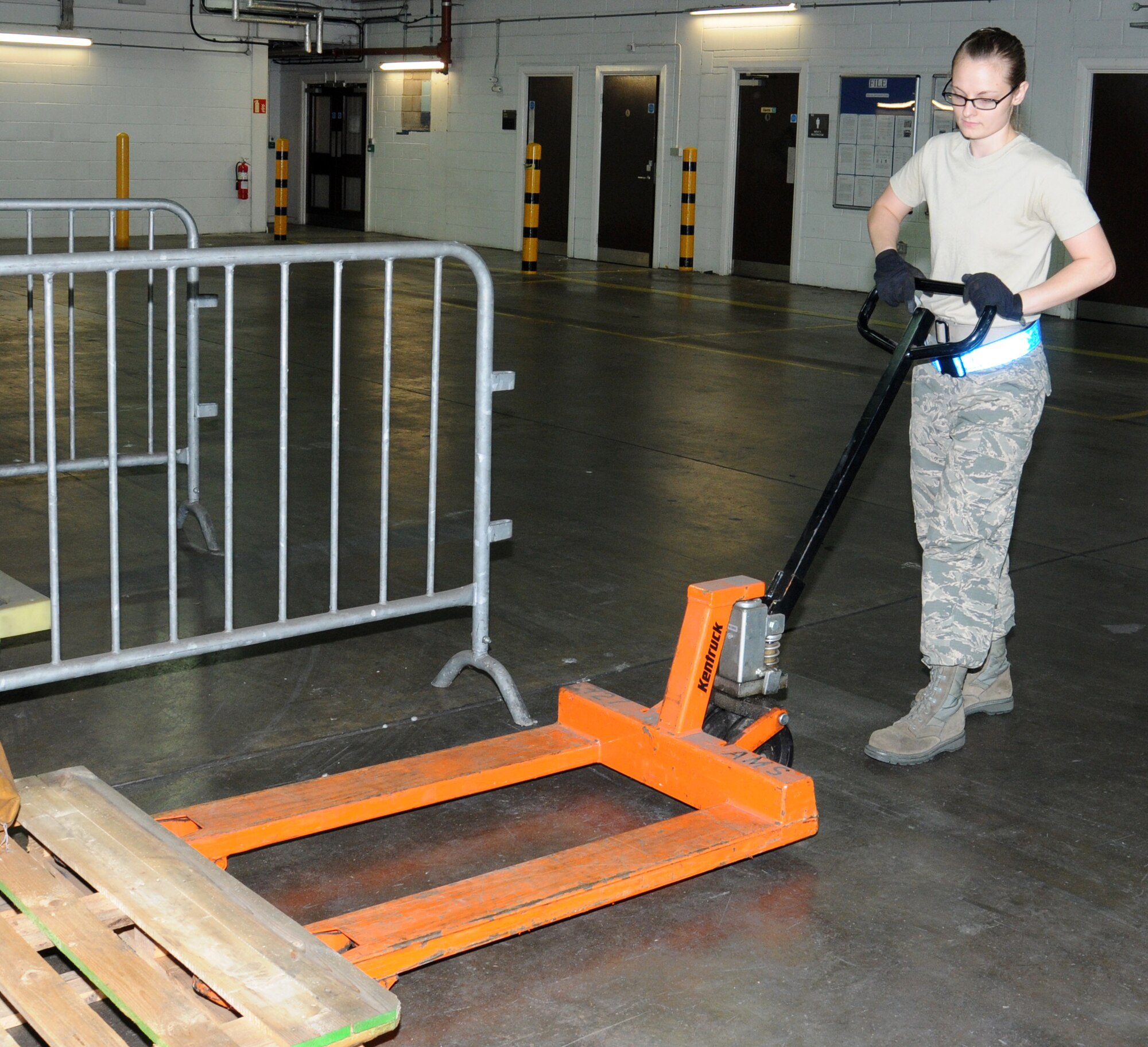 U.S. Air Force Senior Airman Felicia Zimmer, 727th Air Mobility Squadron Air Freight specialist from Nashville, Tenn., uses a pallet jack to move a pallet Sept. 2, 2014, in the freight terminal on RAF Mildenhall, England. Pallets are moved using specialized equipment to ensure the safety of Airmen. (U.S. Air Force photo/Gina Randall/Released)