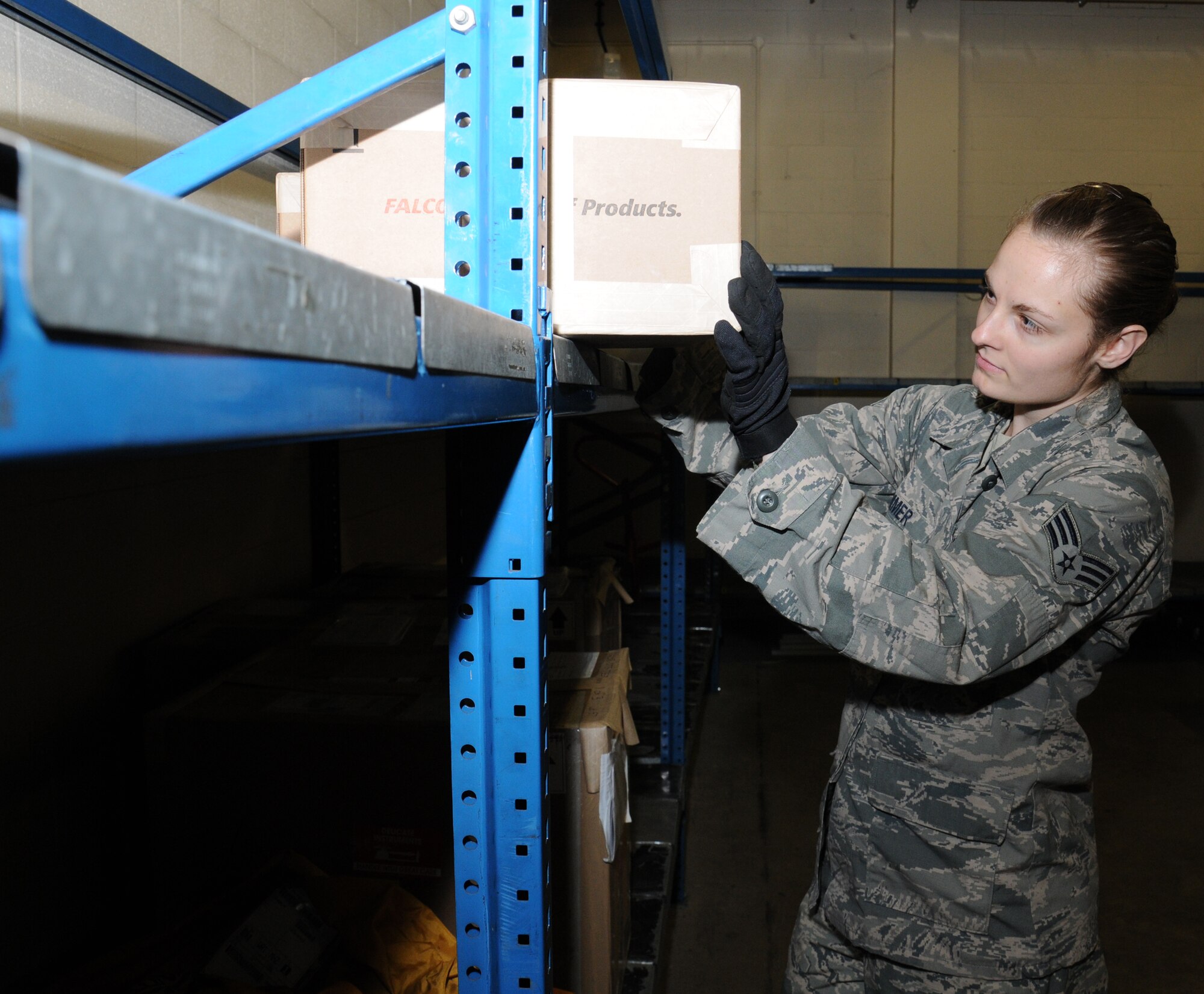 U.S. Air Force Senior Airman Felicia Zimmer, 727th Air Mobility Squadron Air Freight specialist from Nashville, Tenn., checks documentation on a box prior to loading it onto a pallet Sept. 2, 2014, in the freight terminal on RAF Mildenhall, England. Different types of cargo include mail, medical specimens, blood, household goods, courier cargo and human remains. (U.S. Air Force photo/Gina Randall/Released)