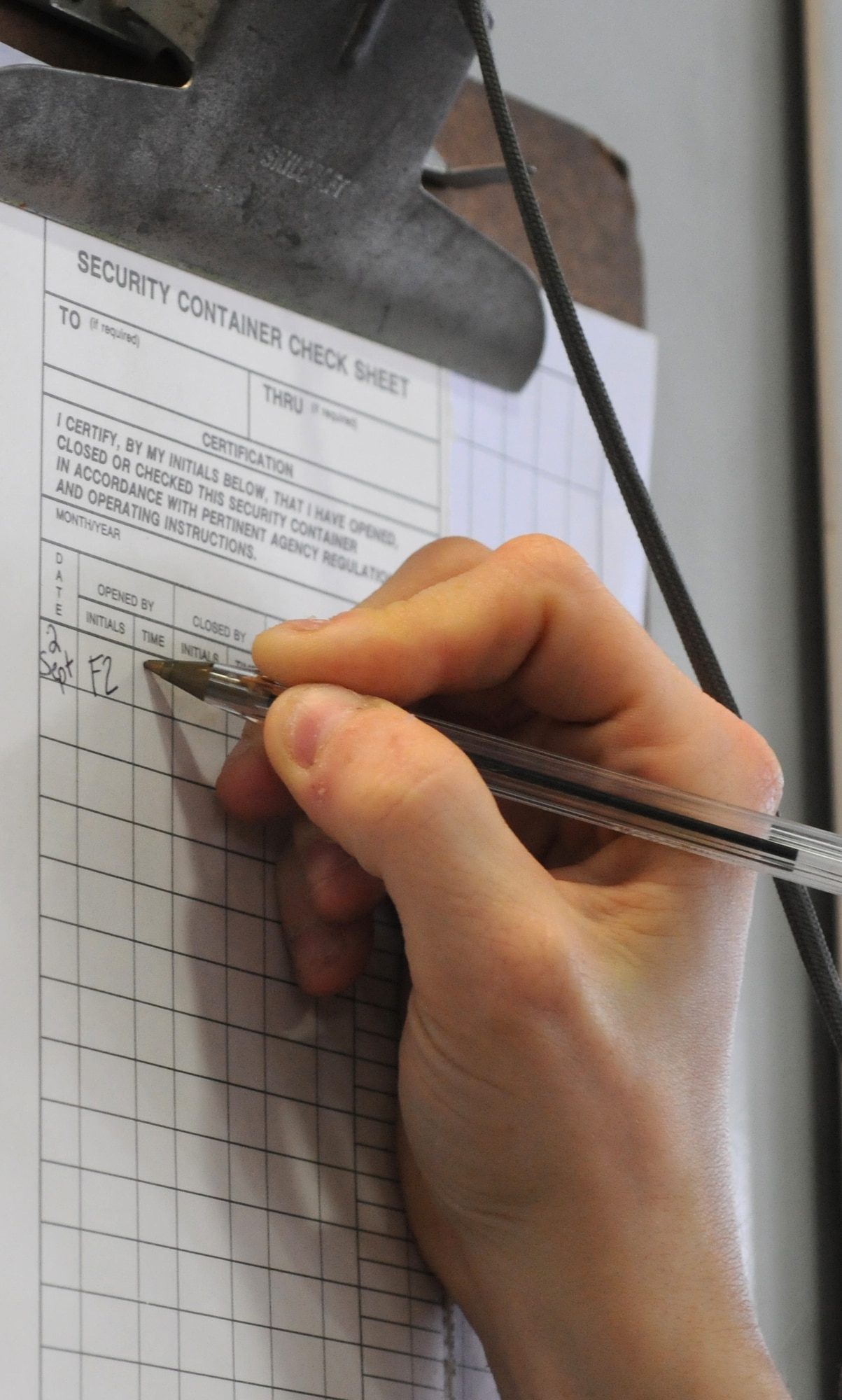 U.S. Air Force Senior Airman Felicia Zimmer, 727th Air Mobility Squadron Air Freight specialist from Nashville, Tenn., marks a security container check sheet Sept. 2, 2014, in the freight terminal on RAF Mildenhall, England. Each time authorized personnel enter or exit the cargo storage area, it must be documented. (U.S. Air Force photo/Gina Randall/Released)