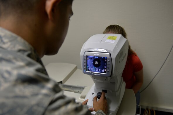 Senior Airman Lloydon Balili, 86th Aeromedical Squadron ophthalmic technician, uses an auto-refractor to determine a patient’s baseline prescription on Ramstein Air Base, Germany, Sep. 30, 2014. As U.S. Air Forces in Europe’s largest optometry clinic, they treat anyone older than 5 years old for anything from retraining physicals to school screenings. (U.S. Air Force photo/Airman 1st Class Michael Stuart) 