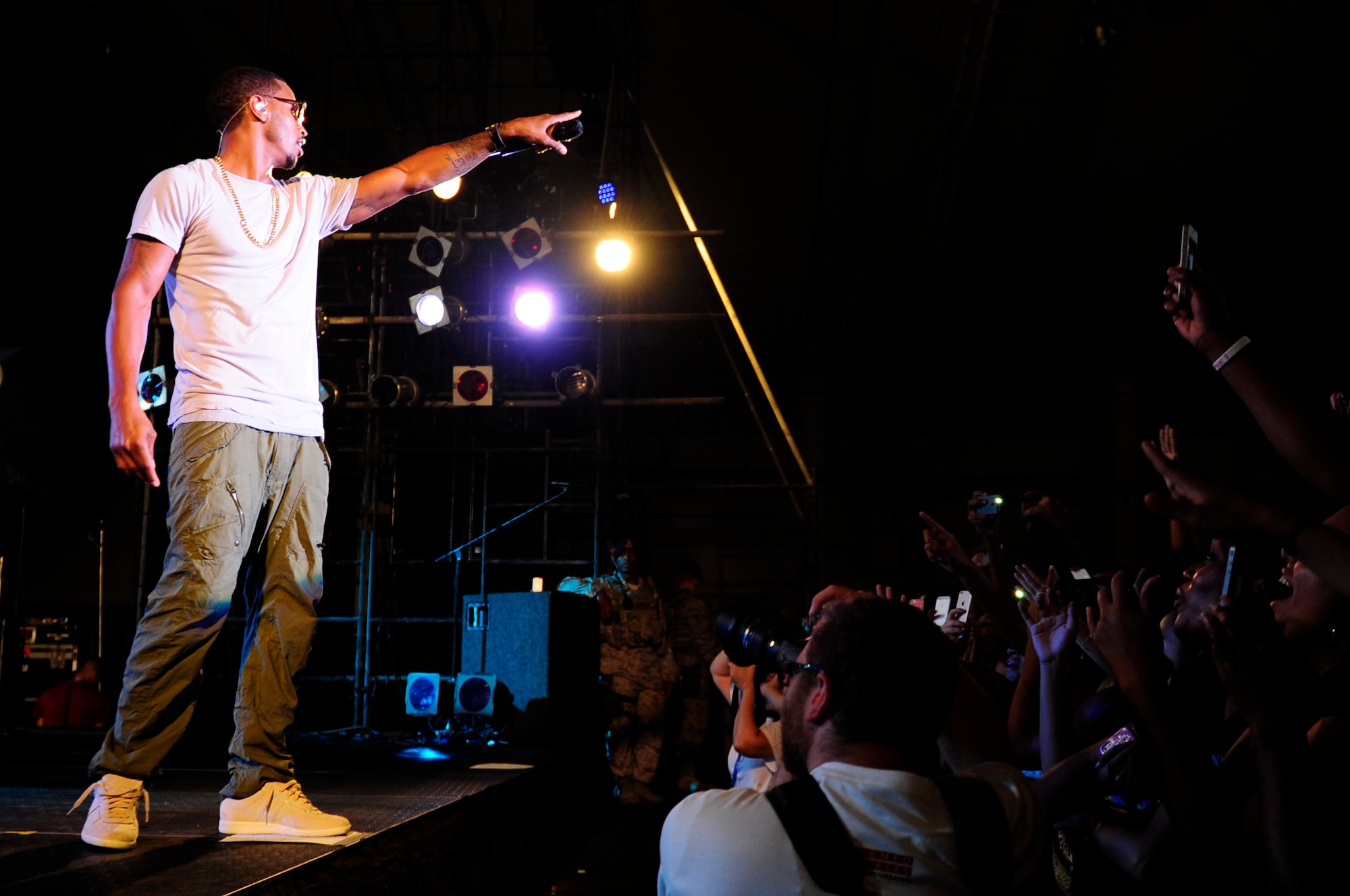 Trey Songz holds out his microphone so that the audience can sing his songs during his concert on Kadena Air Base, Japan, Oct. 4, 2014. Trey Songz performed a variety of songs for military service members and their dependents. During his performance, he thanked the men and women of the armed services for their hard work and sacrifices. (U.S. Air Force Photo by Tech. Sgt. Darnell T. Cannady/Released) 