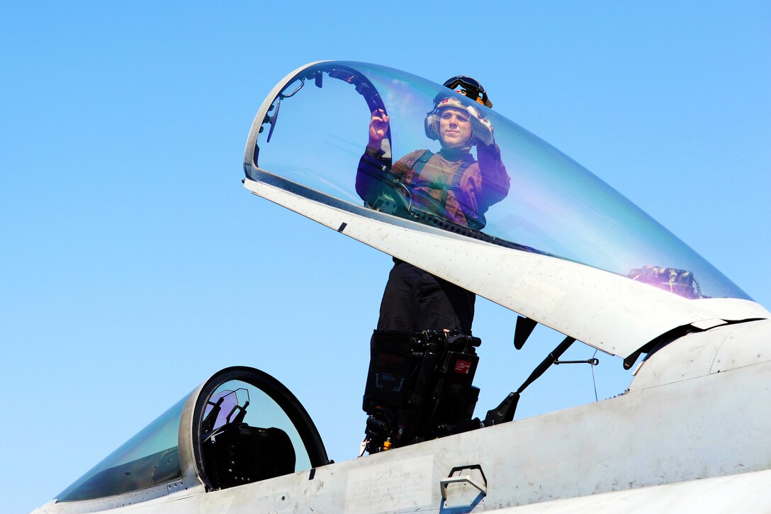 U.S. Navy Seaman Paul Wagner cleans an F/A-18E Super Hornet aircraft assigned to Strike Fighter Squadron 31 aboard the aircraft carrier USS George H.W. Bush in the Persian Gulf, Oct. 2, 2014. Wagner is an airmen.