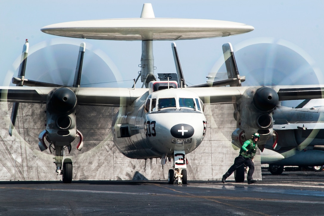 A U.S. Navy E-2C Hawkeye aircraft assigned to Carrier Airborne Early Warning Squadron 124 takes off from the flight deck of the aircraft carrier USS George H.W. Bush in the Persian Gulf, Oct. 2, 2014.