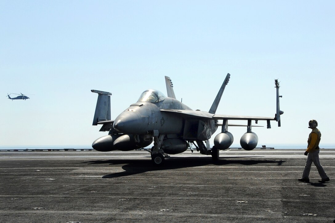 An F/A-18E Super Hornet assigned to Strike Fighter Squadron 31 taxies on the flight deck of the aircraft carrier USS George H.W. Bush in the Persian Gulf, Oct. 2, 2014.