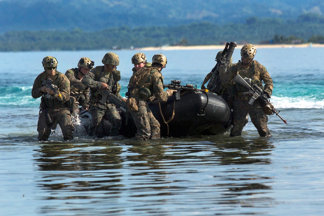 U.S. Marines and Philippine forces jump out of a combat rubber raiding ...