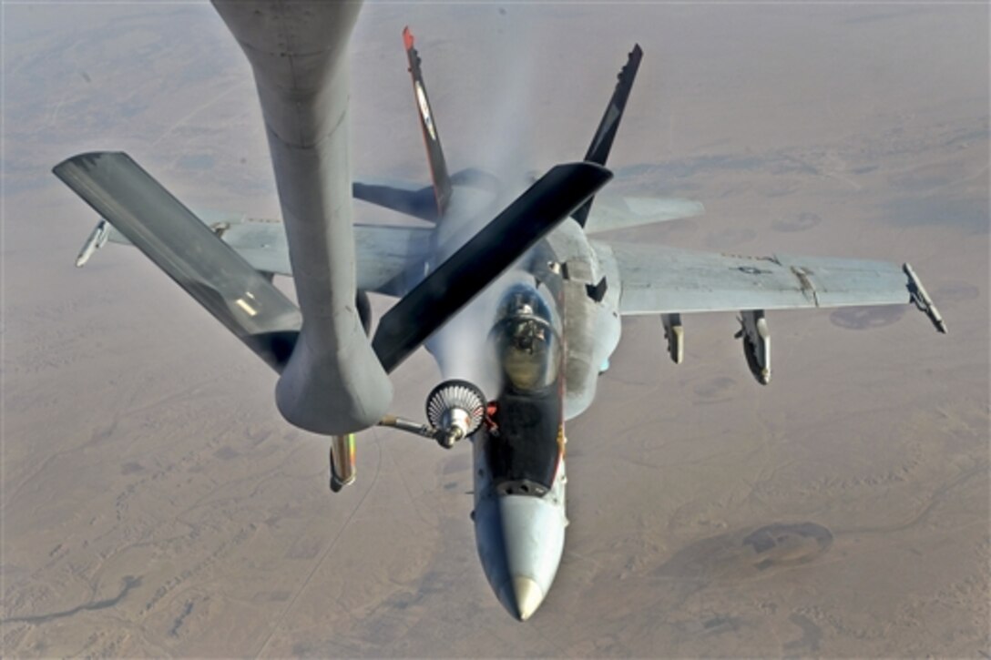 A U.S. Navy F-18E Super Hornet receives fuel from a KC-135 Stratotanker over Iraq before conducting an airstrike, Oct. 4, 2014. The aircraft are supporting operations against the Islamic State of Iraq and the Levant, or ISIL. 