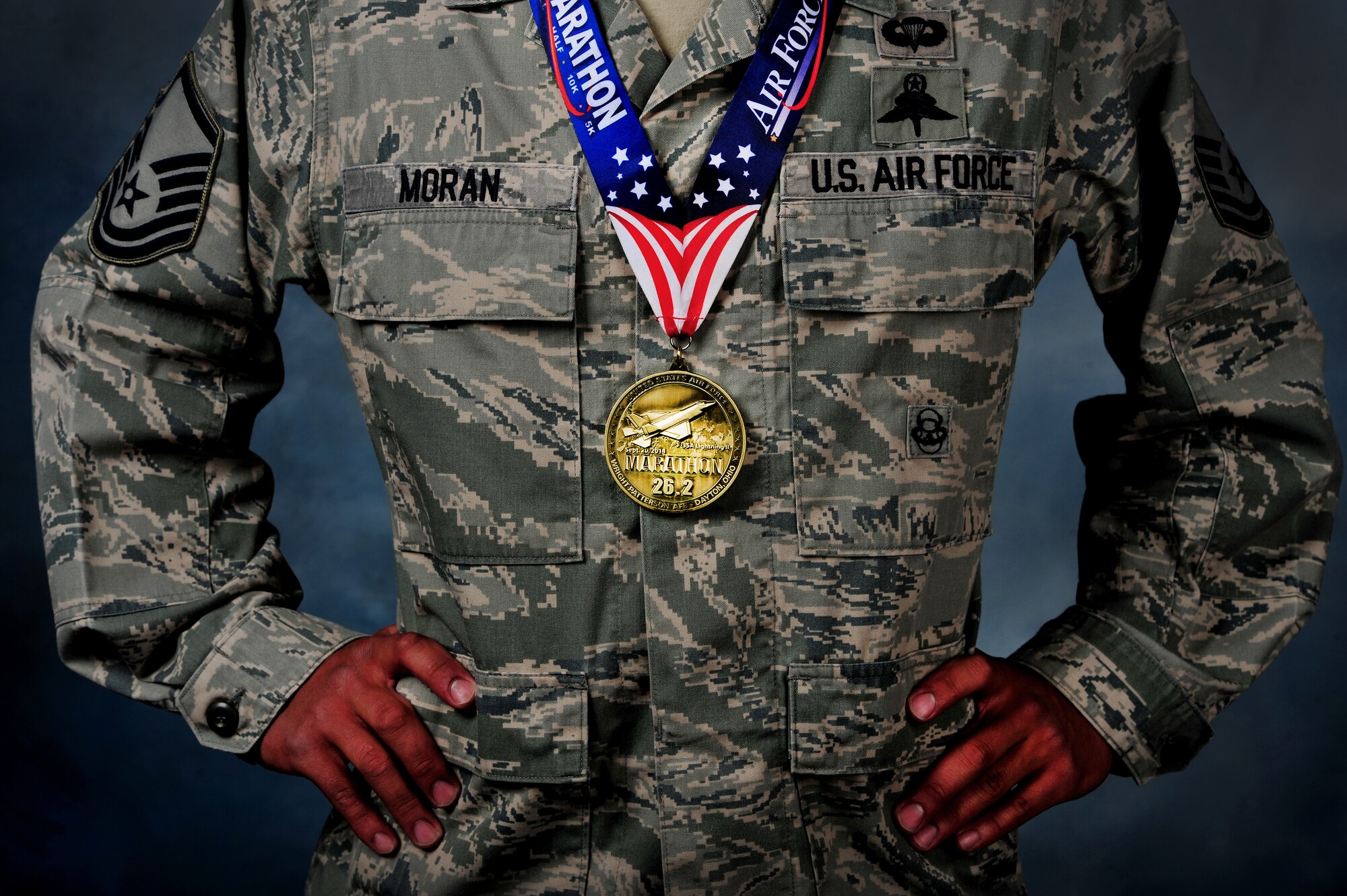 U.S. Air Force Master Sgt. Juanjose Moran, 26th Special Tactics Squadron flight chief, 24th Special Operations Wing, dons his AF Marathon medal.  Moran recently crossed the 2014 Air Force Marathon’s 26.2 mile finish line in 2:37 as the first active duty military winner and third overall finisher. (U.S. Air Force photo/Staff Sgt. Matthew Plew) 