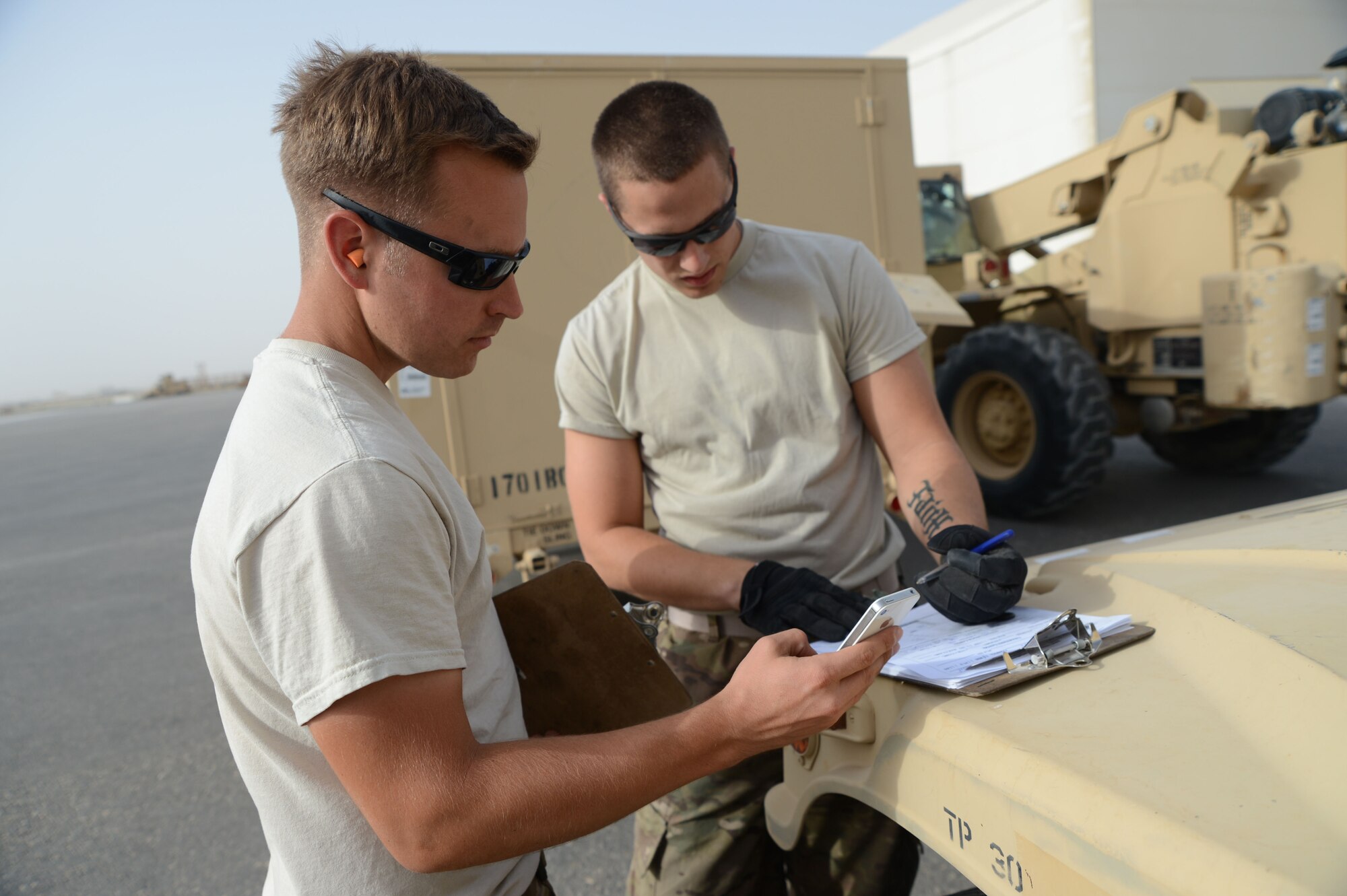 U.S. Air Force Staff Sgt. Michael Middleton and Tech. Sgt. Chaz Jensby verify weights and measurements of a Mine Resistant Ambush Protected All-Terrain Vehicle as part of inspection procedures at Mazar-e Sharif, Afghanistan June 24, 2014. Jensby, a native of Lincoln, Neb., is a reservist deployed from the 155th Air Refueling Wing, Lincoln, Neb., while Middleton is a native of Bonney Lake, Wash., and deployed from the 732nd Air Mobility Squadron at Joint Base Elmendorf-Richardson, Alaska. (U.S. Air Force photo by Master Sgt. Cohen A. Young/Released)  