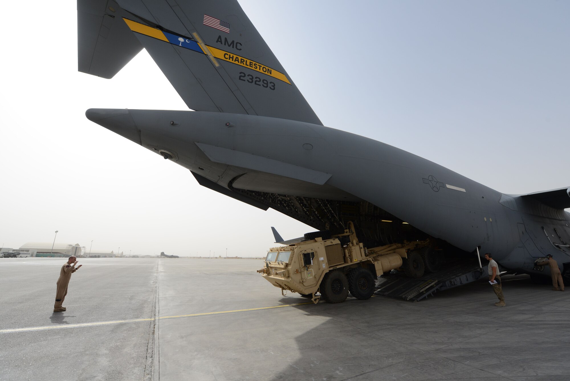 U.S. Air Force Staff Sgt. Doug Wattier, a loadmaster assigned to 816th Expeditionary Airlift Squadron, Detachment 2, directs the driver of a Heavy Expanded Mobility Tactical Truck as he backs onto a C-17 Globemaster III while at Mazar-e Sharif, Afghanistan June 24, 2014. Loadmasters are responsible for ensuring the proper loading of vehicles, pallets and equipment on aircraft. Wattier, a native of Jacksonville, N.C. is deployed from the 317th Airlift Squadron at Joint Base Charleston, S.C. (U.S. Air Force photo by Master Sgt. Cohen A. Young/Released)  