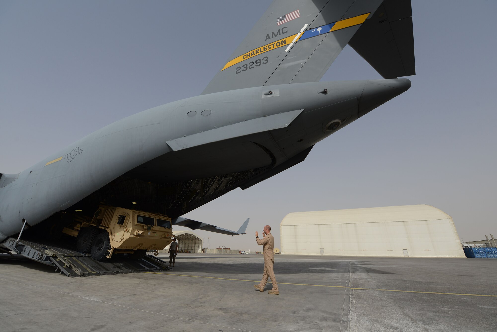U.S. Air Force Staff Sgt. Doug Wattier, a loadmaster assigned to 816th Expeditionary Airlift Squadron, Detachment 2, directs the driver of a Heavy Expanded Mobility Tactical Truck as he backs onto a C-17 Globemaster III while at Mazar-e Sharif, Afghanistan June 24, 2014. Loadmasters are responsible for ensuring the proper loading of vehicles, pallets and equipment on aircraft. Wattier, a native of Jacksonville, N.C. is deployed from the 317th Airlift Squadron at Joint Base Charleston, S.C. (U.S. Air Force photo by Master Sgt. Cohen A. Young/Released)  